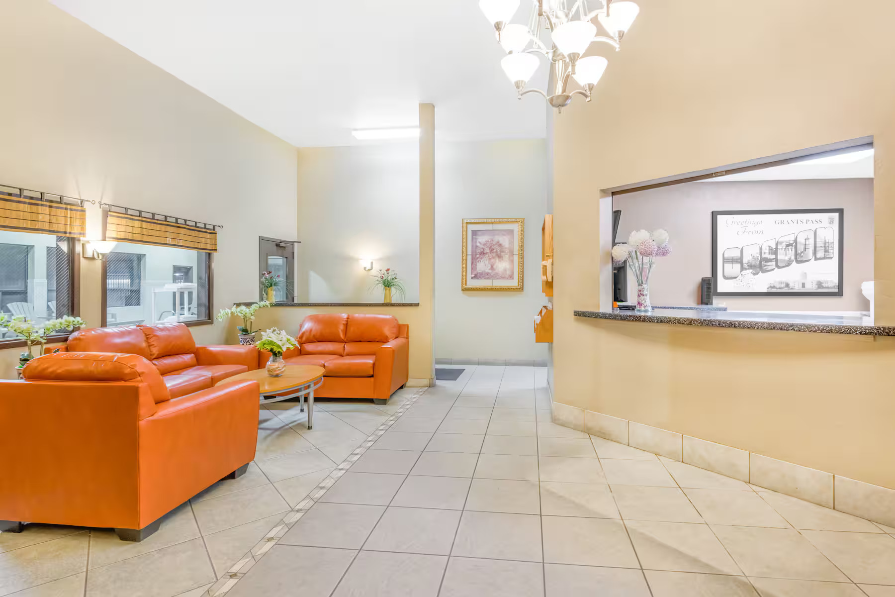 Woman meditating on a boat in a lake surrounded by green cliffs